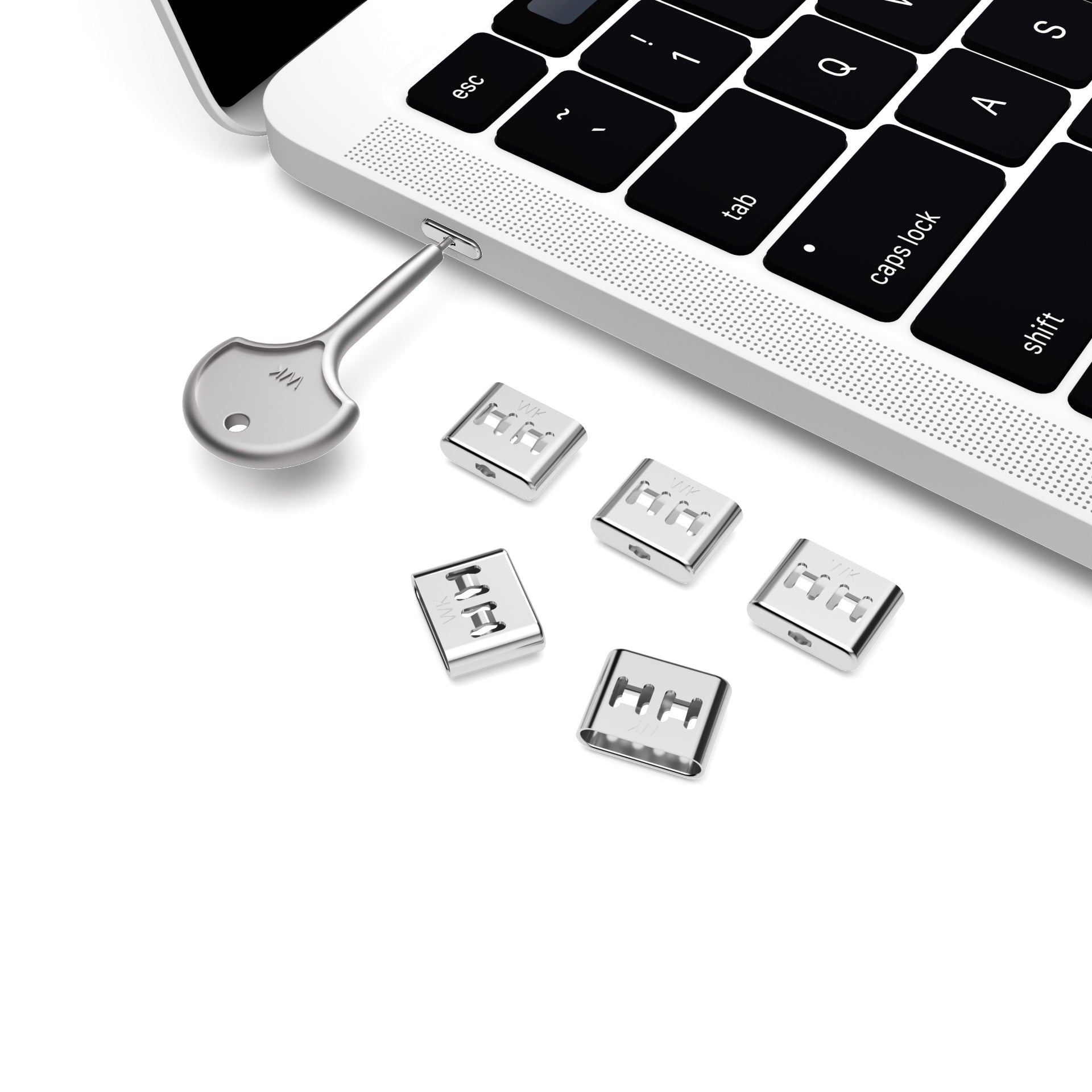 Silver key inserted in laptop side port with five small rectangular silver port covers on white background.