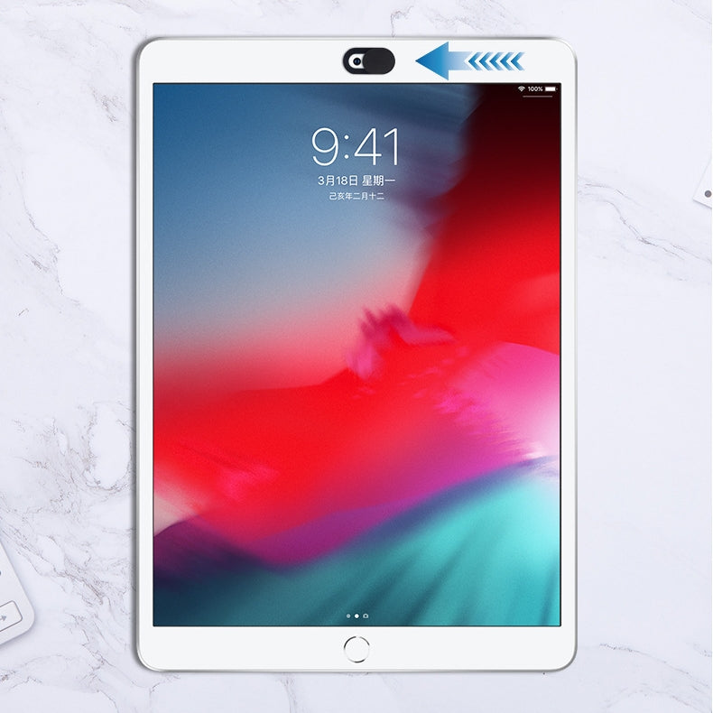 White tablet with a black oval webcam cover attached at the top, shown partially slid open.