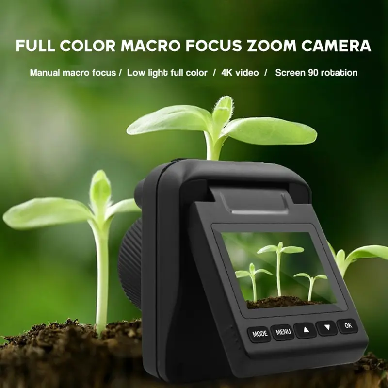 A single black macro camera with a flip screen showing a close-up of green plant sprouts in soil.